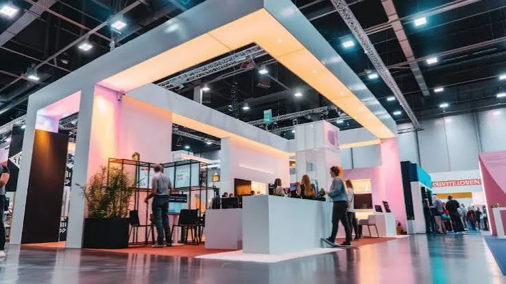 Exhibitor Lead Retrieval UAE 1 Modern exhibition stand with visitors speaking to staff at a counter